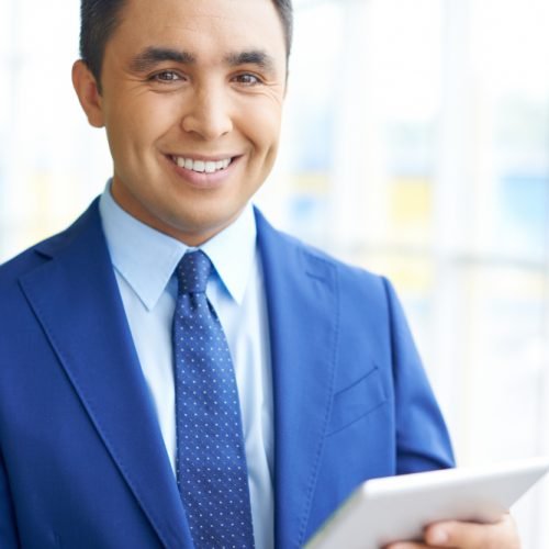 smiling-businessman-with-touchpad