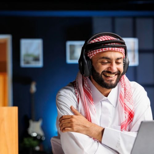 utilizing-wireless-technology-muslim-man-engages-online-research-communication-showcasing-his-expertise-commitment-his-profession-arab-guy-using-headphones-laptop